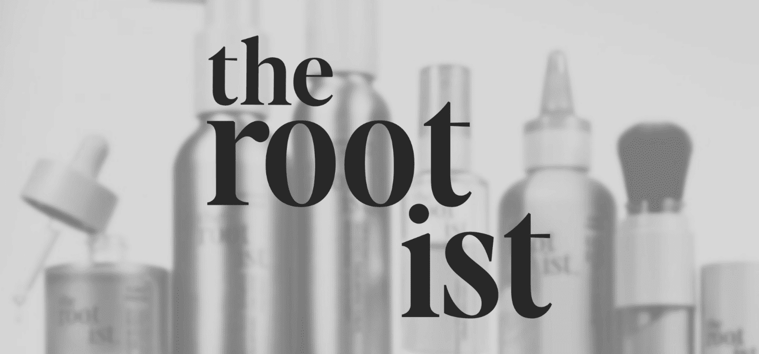 The Rootist skincare products in sleek, minimalist packaging with a blurred background.