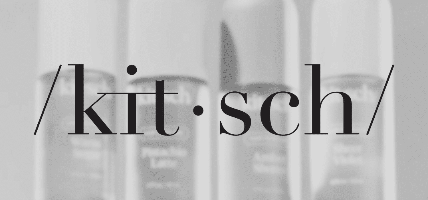 Kitsch text over blurred background of skincare products.